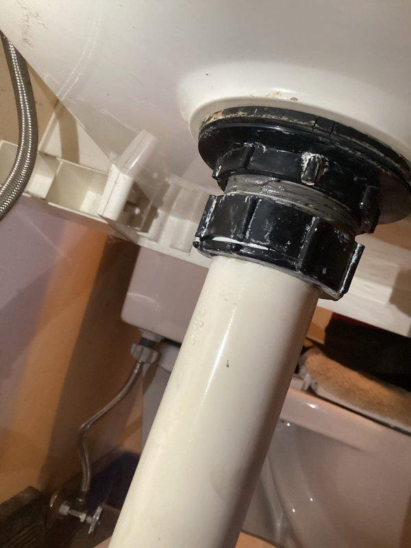 Responded to follow-up call regarding dripping noise in laundry room after previous burst pipe repair. Upon inspection, identified two sources of water leakage: a loose washing machine supply hose connection and a cracked slip nut on the laundry tub drain assembly. Tightened the washing machine hose to proper torque specifications to eliminate leak at connection point. Replaced the damaged slip nut and deteriorated tee gasket on the laundry tub drain system with new components to restore proper seal and prevent further water intrusion. Verified all connections were secure and leak-free before restoring water supply to the home.