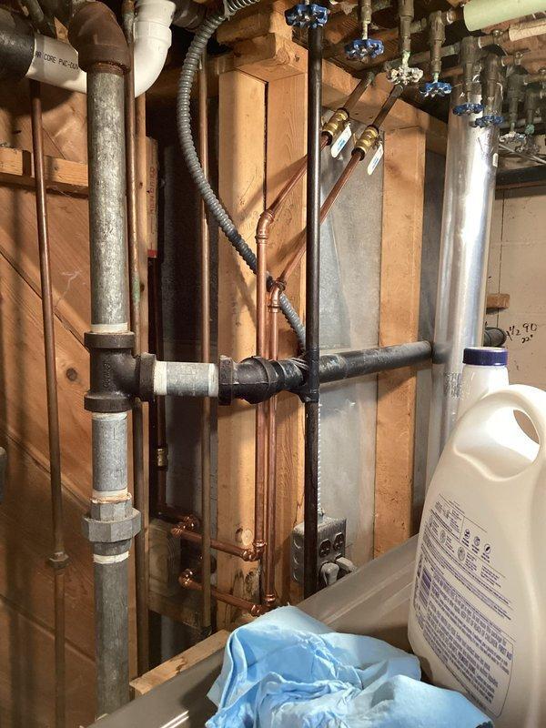 Completed installation of partially installed Delta shower control valve in basement shower. The valve body had been previously set in place but required final assembly and finishing work. Installed trim components including chrome escutcheon plate and single-handle lever control with hot/cold indicators. Verified proper valve operation and water flow control. All connections secured and fixture mounted flush to wall surface for clean, functional appearance.