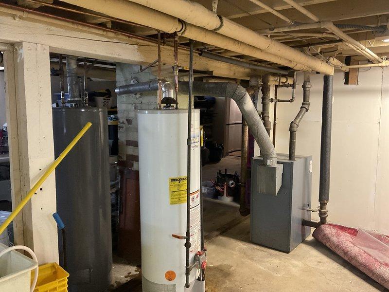 Responded to emergency water leak caused by failed valve on cold water supply line to water heater. Main water supply was shut off upon arrival to prevent further damage. Removed defective valve and installed new ball valve on cold side of water heater using proper copper pipe connections. New valve was left in closed position after installation due to separate leaking condition identified on the water heater tank itself, which had been previously estimated for replacement with a power vent unit to accommodate existing chimney configuration.