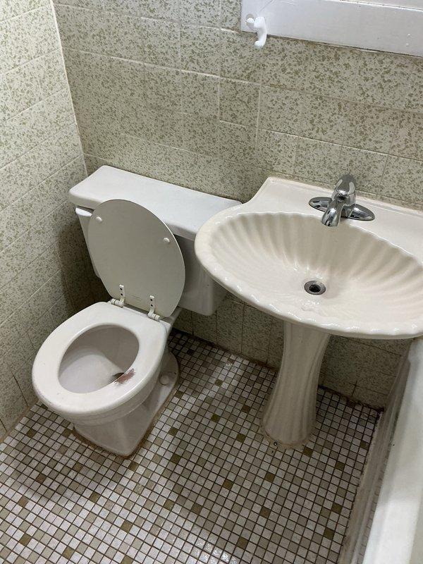 Responded to service call for property that had been winterized and shut down. Upon arrival, assessed plumbing systems throughout the residence. Inspected non-functional toilet in bathroom with pedestal sink, noting facility required reactivation after extended closure. Evaluated kitchen sink with reported drainage issues. Documented bathroom conditions including toilet, pedestal sink with chrome fixtures, and bathtub/shower combination showing signs of extended disuse and deteriorated caulking at seams. Tested plumbing systems to determine extent of winterization impact. Coordinated with advisor to provide comprehensive bid for necessary repairs and system restoration to bring all fixtures back to operational status.