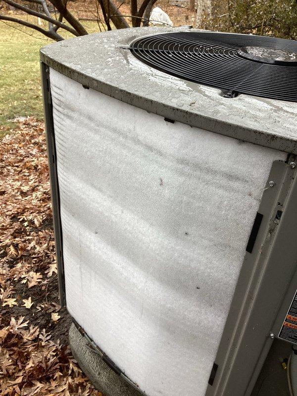 Responded to service call for heat pump making loud noise every 30 seconds with flickering lights and irregular cycling. Upon inspection, found outdoor coil completely iced over, preventing proper system operation. Verified thermostat settings, wiring connections, and outdoor temperature sensor functionality—all reading correctly. Adjusted defrost cycle settings to extended mode to allow thorough coil thawing. Monitored system through multiple heating cycles to confirm proper defrost operation, heat pump functionality, and automatic changeover to auxiliary furnace heating. System restored to normal operation with proper cycling between heat pump and furnace modes.