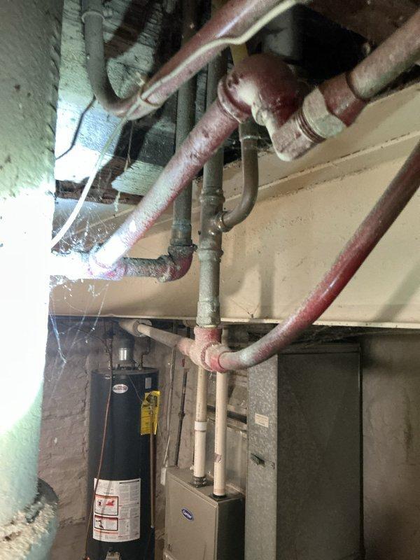 Responded to low hot water pressure complaint, particularly affecting upstairs fixtures. Upon inspection, identified aging galvanized piping system and older water heater as primary causes of reduced flow. Cold water pressure remained adequate throughout the property. Documented existing plumbing infrastructure conditions with photographs and provided estimate for complete system replacement to restore proper water pressure and prevent future issues.