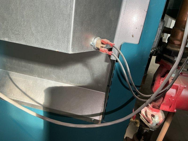 Returned to site following chimney repair to restart boiler system that had been shut down due to exhaust spillage from chimney cave-in. Reset exhaust spill switch and performed system restart procedures. Verified proper venting and combustion operation. Boiler is now fully operational with all safety controls functioning correctly.