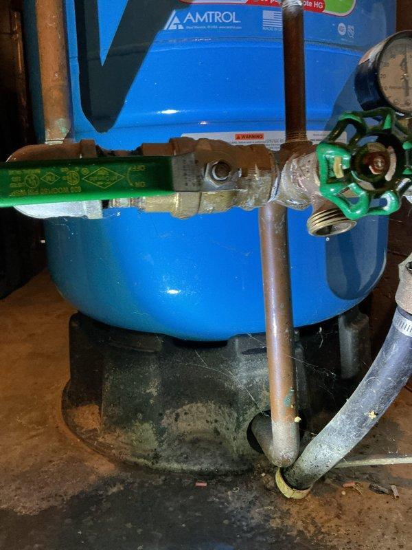 Responded to service call for leaking ball valve near AMTROL water pressure tank in basement. Identified source of leak causing water puddles on concrete floor. Replaced damaged ball valve and small section of connecting copper pipe to resolve the slow drip that customer reported had been ongoing for approximately two years.