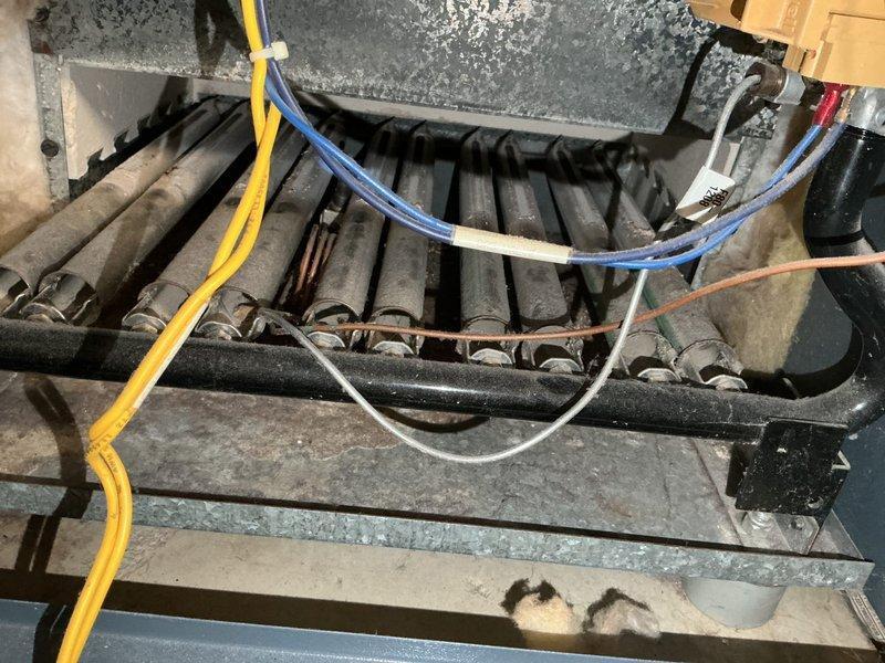 Performed 8-12 tune-up and cleaning on 30+ year old boiler that was failing to maintain temperature above 60 degrees. Cleaned burners and burner chamber, but discovered severely plugged and deteriorating heat exchanger with dangerous CO readings (over 100 ppm in flue, 2 ppm leakage outside jacket). System operating at sub-70% efficiency with buzzing transformer/relays and leaking gate valve. Recommended immediate boiler replacement due to safety concerns.