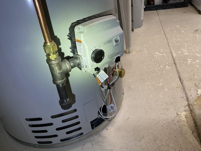 Responded to customer concern about insufficient hot water from recently installed water heater. Diagnosed issue as temperature setting that had been turned down by unknown person. Measured water temperature at utility sink (100°F) and adjusted thermostat on EcoSystem control unit to proper "Hot" setting (120°F).