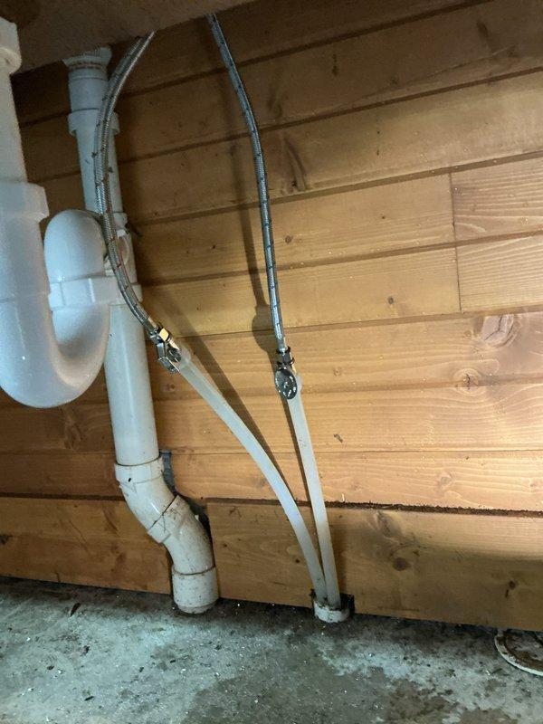 Replaced customer-supplied faucet on utility sink in garage, which included installing a new shut-off valve. Inspected existing PVC drainage system and supply lines mounted on wooden wall panel, ensuring proper connection to new fixtures and verifying system functionality after installation.