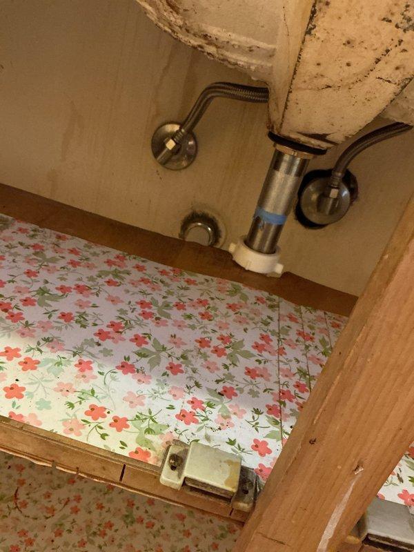 Disconnected and removed two toilets and two bathroom vanities from property that experienced flooding due to frozen pipes while owners were away. Documented existing plumbing conditions with photos, including water supply lines, drain connections, and water damage to surrounding areas. Scheduled follow-up appointment for reinstallation after restoration company completes remediation work.