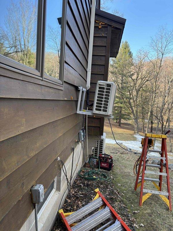 Responded to service call for a Lennox mini-split condenser unit that was improperly mounted and pulling away from the house siding. Technician reclaimed refrigerant, removed the unit, and properly reinstalled the mounting bracket using longer lag bolts secured to wall studs. After reinstallation, the system was evacuated, charged, and tested for proper operation, resolving the safety hazard and ensuring correct unit function.