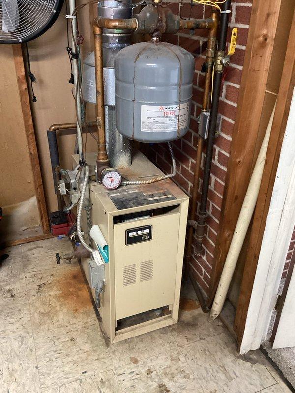 Responded to service call for Weil-McLain boiler system with complaint of new pump making loud noise and heating inconsistency. Diagnostic inspection revealed air trapped in system with no available bleeders. Recommended return visit by technician equipped to purge air from system or install appropriate bleeders to resolve noise issue and restore proper heating function.