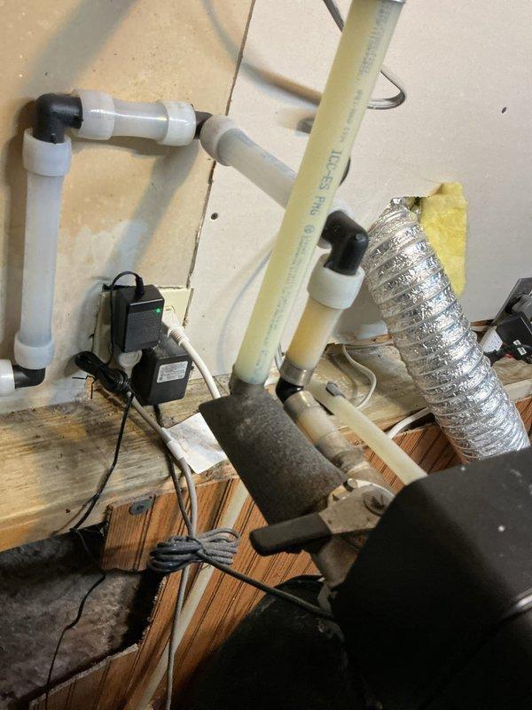 Responded to service call regarding dead fish odor from water system installed one month prior. Diagnosed issue with acid neutralizer causing strong fish smell, particularly pronounced in hot water supply. Tested water softener functionality (confirmed working), then bypassed softener and drained water heater which significantly reduced odor. Provided customer with instructions for properly flushing the water softener system to potentially resolve the remaining odor issue.