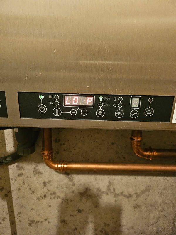 Diagnosed boiler system displaying "LOP" error code due to loss of pressure (0 psi). Located pinhole leak in pump housing causing significant water damage. Replaced defective circulator pump, bled air from system, and restored proper pressure. Remained on site until heat distribution was confirmed with warm returns. System now operating normally.