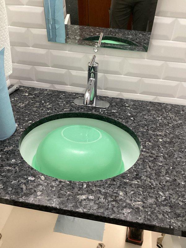 Replaced customer-supplied faucets in two locations: installed a modern chrome single-lever faucet in the bathroom where cold water flow was compromised, and replaced an aging kitchen faucet with a new high-arch pull-down sprayer model. Both installations were completed successfully with proper function verified.