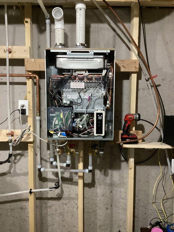 Diagnosed tankless water heater with no hot water issue. Performed maintenance including clearing condensate line, cleaning exhaust/intake, and cleaning igniters. System continued to display Error 11 (no ignition); recommended replacement of igniter assembly.