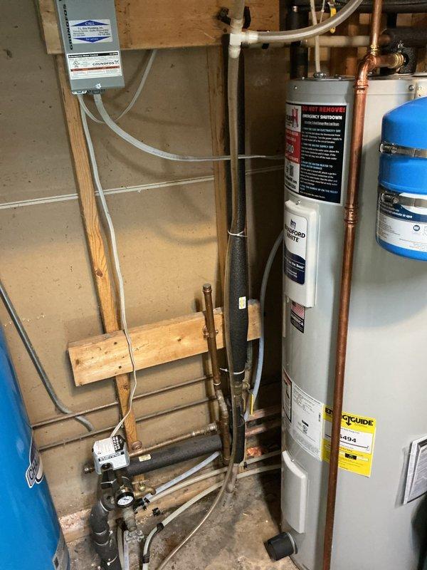 Performed follow-up visit for persistent fish-like odor in water supply after previous softener sanitization attempt failed to resolve the issue. Inspected dual water treatment system consisting of water softener with digital control head and larger secondary treatment tank. Customer informed that estimates for carbon filtration system installation have been provided as recommended solution to eliminate odor, and they are reviewing options before proceeding with treatment upgrade.