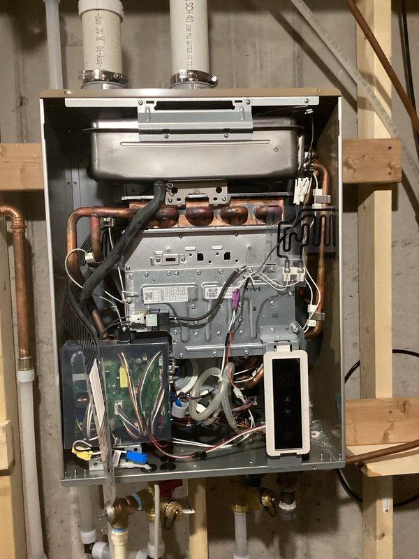 Responded to service call for 12-4 LP water heater under Richmond warranty. Performed diagnostic assessment and measured gas flow rate per manufacturer's request. Inspection revealed improper venting configuration and undersized gas line supplying the unit. Documented internal components and installation conditions with photographs. Provided estimate for replacement with 50-gallon propane power vent water heater to address code compliance issues and ensure proper operation.