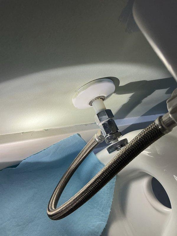 Responded to a toilet leak originating from the wall-side water supply connection. Upon inspection, identified a failed shut-off valve as the source of the leak. Replaced the defective shut-off valve with a new fixture-quality supply valve and verified proper sealing at all connection points. System tested and confirmed leak-free operation with no further water discharge detected.