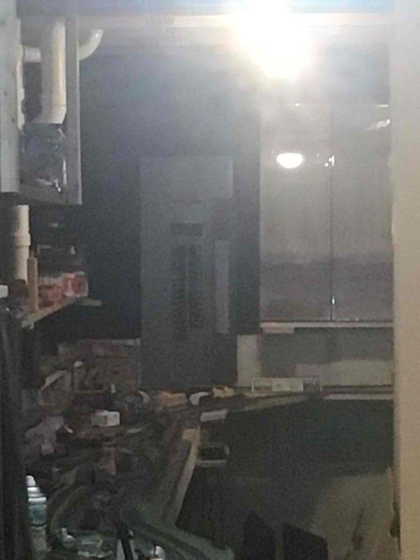 Responded to reported LP gas odor near range and in basement area. Performed systematic leak detection, beginning with inspection of range connection and gas supply line. No leak detected at stove location. Traced gas distribution system to basement branch line and identified loose fitting on gastite flexible gas line. Tightened fitting to proper torque specification and confirmed leak elimination through soap bubble test. System restored to safe operating condition.