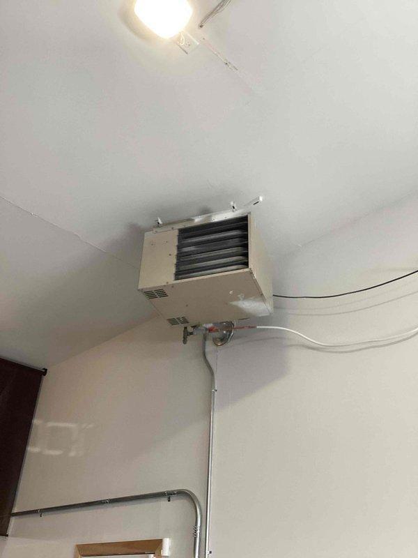 Responded to no-heat call for wall-mounted garage heater that was previously serviced. Diagnosed system, which fired up and operated normally during 20-minute test run. Performed preventative maintenance including cleaning flame sensor and igniter. Verified proper gas pressure and confirmed all electrical components and settings were functioning correctly. Unit now operating as designed with customer instructed to monitor and report if issue recurs.