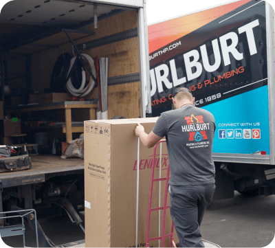 Warehouse Associate loading furnace into truck